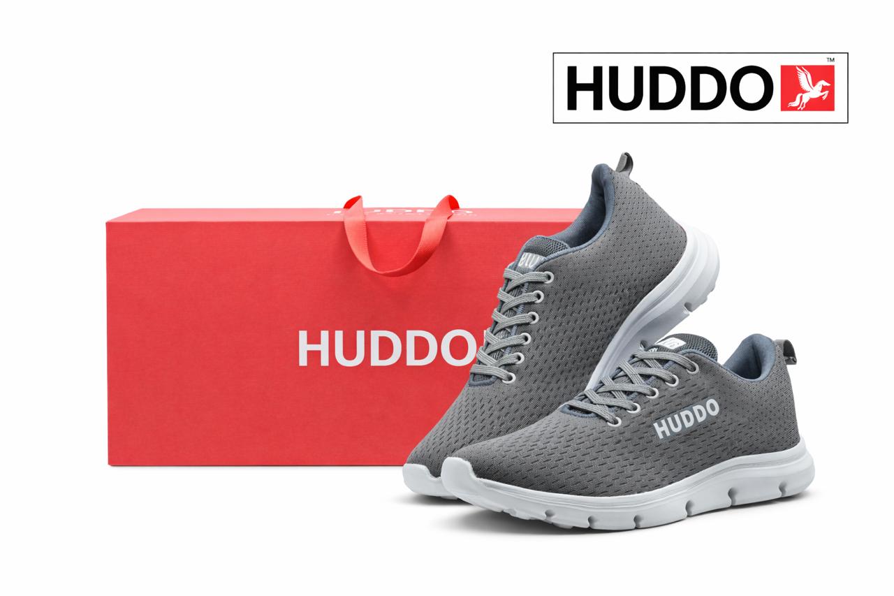 Gray running shoes with white soles next to a red HUDDO box on a white background